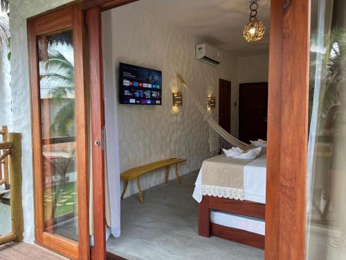 a hotel room with a bed and a sliding glass door at Casa di Maria flats in Icaraí
