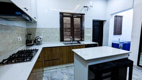 a kitchen with a stove and a white counter top at Amazing Shortlet in Lekki