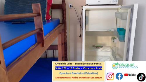 a small room with a bunk bed with a small refrigerator at Arraial do Cabo – Subuai Village - Aluguel Econômico in Arraial do Cabo