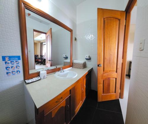a bathroom with a sink and a mirror at Hotel Centenario in Puerto Maldonado