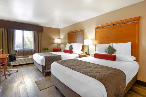 a hotel room with two beds and a desk at Best Western Prineville Inn in Prineville