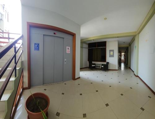 an empty hallway with a door in a building at Hotel Centenario in Puerto Maldonado