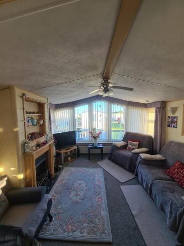 a living room with a couch and a tv at 5 Berth Family Caravan Ingoldmells in Skegness