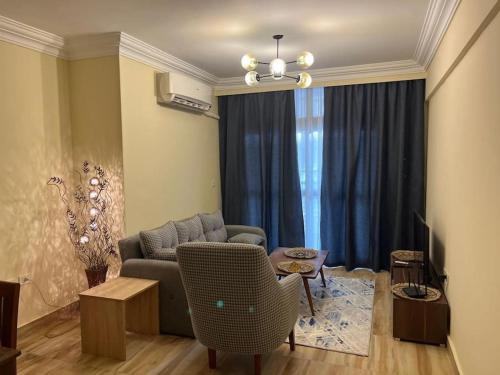 a living room with a couch and a table at Comfort Plaza A in Cairo