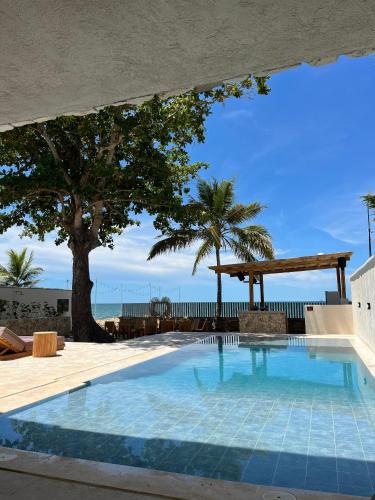 a swimming pool with a view of the beach at Talam House Coveñas by Bernalo Hotels in Coveñas