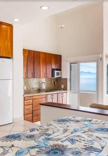 a kitchen with a bed and a counter top at Oceanfront-Ocean View in Bucerias Casita Oasis Condo - Large Studio in Bucerías