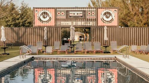 a pool with a house with a record player at DayDreamer Domes in South Haven