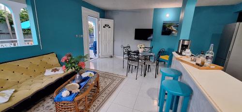 a living room with a couch and a dining room at Anse Maurice Évasion in Petit-Canal