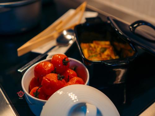 a bowl of tomatoes sitting on top of a stove at Barrilario Douro Wine Hotel e Spa - Quinta São Jose do Barrilario in Armamar