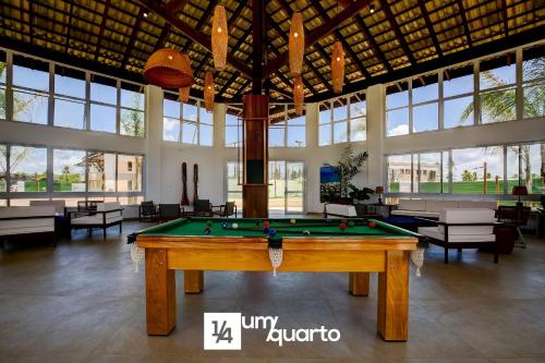 a pool table in a large room with windows at Ponta de Inhambupe Residences in Baixio