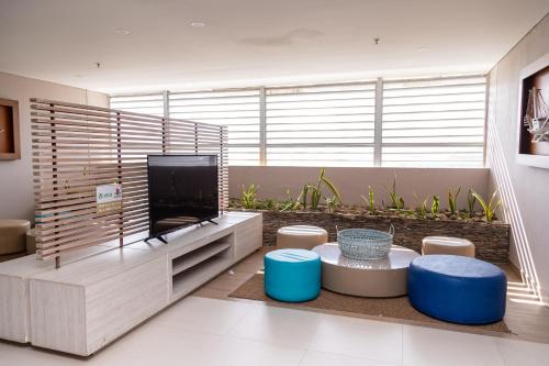 a living room with a tv and a large window at Apartamentos Luxury Frente al Mar - AR Rentals in Gaira