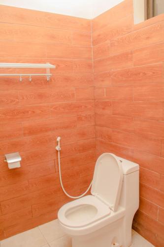 a bathroom with a toilet with a hose at Royal Village Dodoma in Dodoma
