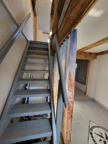 a staircase in a house with wooden ceilings at Landliebe am Stettiner Haff in Grambin