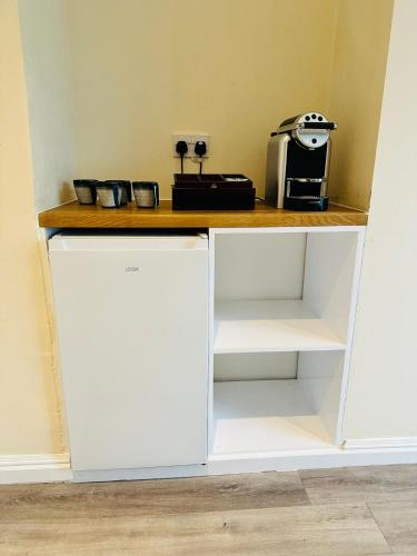 a white counter with a coffee maker on top of it at Castle View, 94-96 Friar Lane in Nottingham