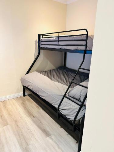 a bunk bed in a room with a wooden floor at Castle View, 94-96 Friar Lane in Nottingham