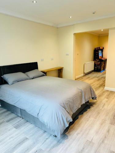 a bedroom with a large bed with a wooden floor at Castle View, 94-96 Friar Lane in Nottingham