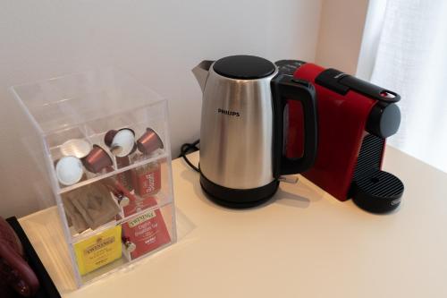 a coffee maker sitting on a counter next to a box at Palazzo Biasini by Postcardsfrom in Verona