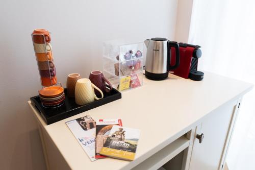 a counter with a coffee maker and other items on it at Palazzo Biasini by Postcardsfrom in Verona