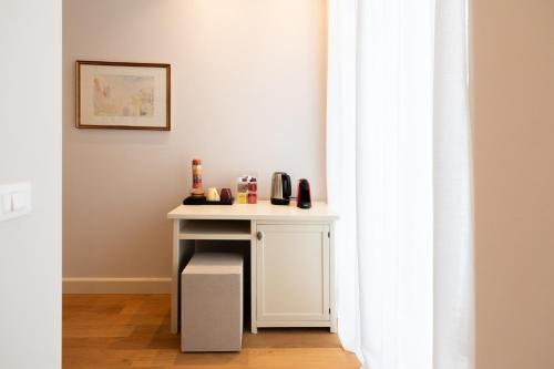 a small white table in a room with a window at Palazzo Biasini by Postcardsfrom in Verona