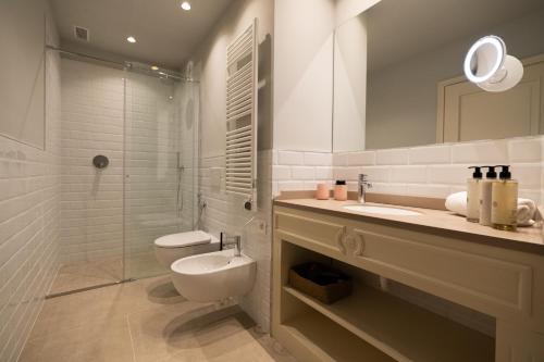 a bathroom with a toilet and a sink and a shower at Palazzo Biasini by Postcardsfrom in Verona