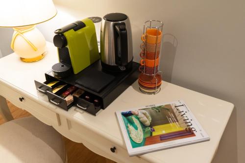 a table with a coffee maker and a book on it at Palazzo Biasini by Postcardsfrom in Verona