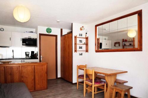 une cuisine et une salle à manger avec une table dans une pièce dans l'établissement Résidence Le Cairn - Résidence Cairn - Studio 4 personnes vue pistes MAE-6381, aux Orres