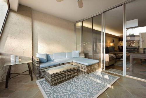 a living room with a blue couch in a room with a living room at Old Town Condo with 2 King Size Suites in Scottsdale