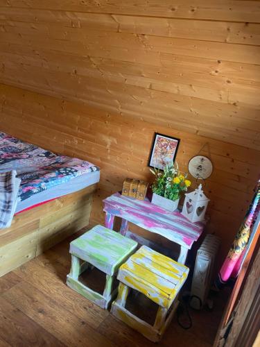 a room with a bed and a table in a cabin at The Hideaway Muff in Muff