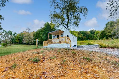 a house on a dirt hill with a porch at Shirley Whirley in Maynardville