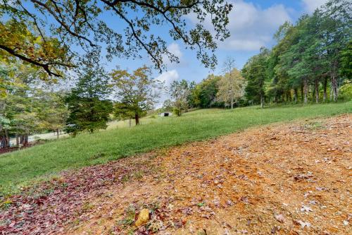 a dirt road in a field with trees at Shirley Whirley in Maynardville