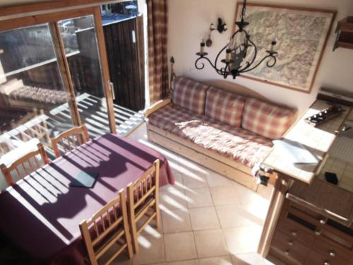 a living room with a couch and a table and chairs at Résidence Le Reclaz - 2 Pièces pour 5 Personnes MAE-3330 in Champagny-en-Vanoise