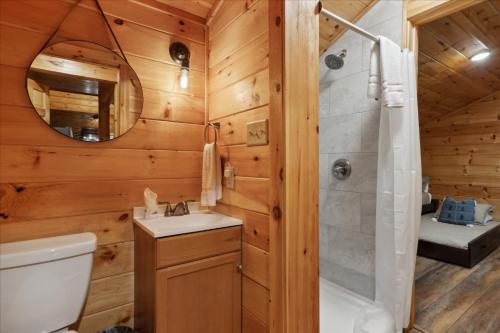 a bathroom with a shower and a toilet and a sink at The Cabin That Plays Hard & Rests Easy Black Bear Lodge in Pigeon Forge