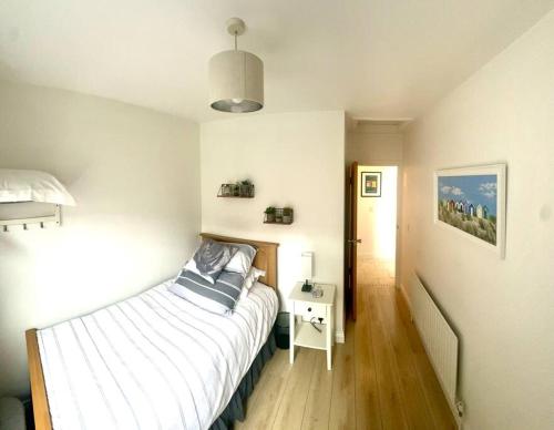 a small bedroom with a bed and a night stand at 55 Malin Road in Moville