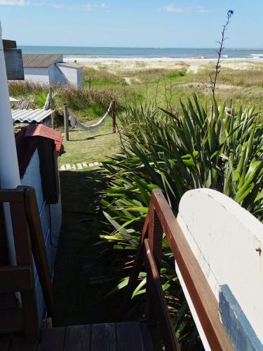 a view of the beach from the porch of a house at Carmela Suites Cabo Polonio in Cabo Polonio