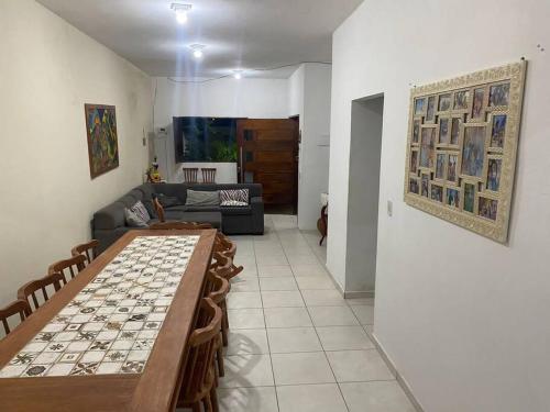 a living room with a table and a couch at Casa de praia em Paripueira in Paripueira