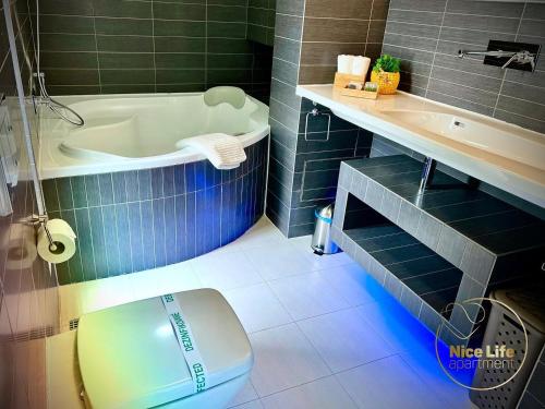 a bathroom with a toilet and a tub and a sink at NICE LIFE - Luxury apartment in the Old Town. in Bratislava