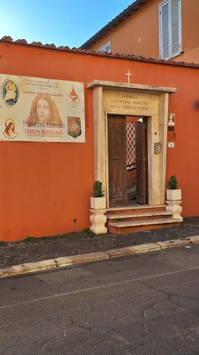 a orange building with a sign on the side of it at Bell'Aria Nettuno in Nettuno