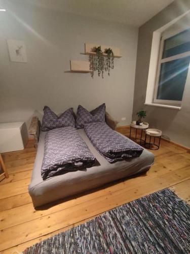 a bedroom with a bed with pillows and a rug at Spacious Room in Tyrolean Flat in Innsbruck