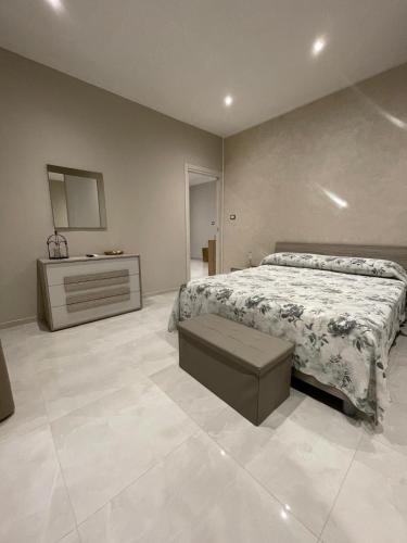 a large bedroom with a bed and a dresser at C&C Apartment in Pontecagnano