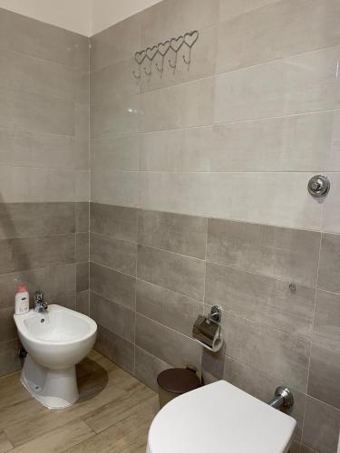 a bathroom with a toilet and a sink at C&C Apartment in Pontecagnano