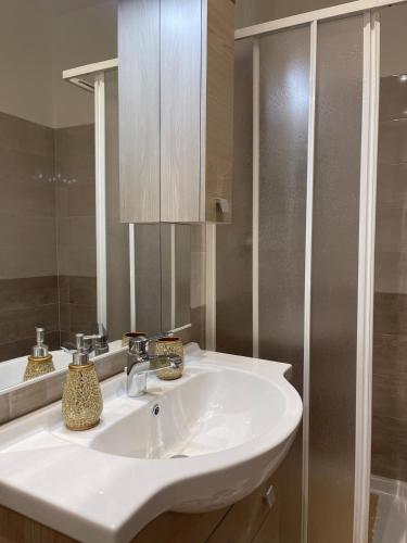 a bathroom with a white sink and a mirror at C&C Apartment in Pontecagnano