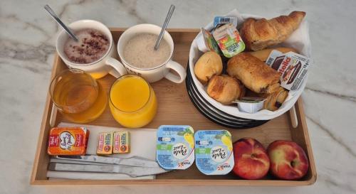 a tray of breakfast foods and drinks on a table at Love Room - Cocon Room - Toulon - Ollioules in Ollioules