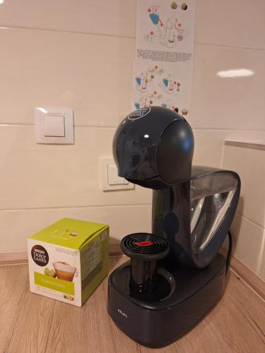 a black coffee maker sitting next to a box at Apartman Lory, Zagreb, Downtown, with own parking in the garage in Zagreb