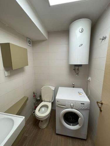 un piccolo bagno con WC e lavatrice di Spring apartment a Skopje