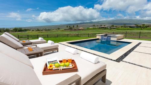 a patio with a pool and a table and chairs at HOKU LANI HOUSE Heated Private Pool Spa Intro Pricing 25% off in Waimea