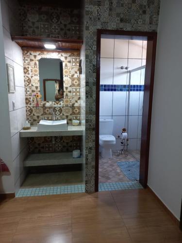 a bathroom with a sink and a toilet at Pousada Cachoeiras do Cipó in Serra do Cipo