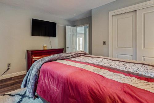 a bedroom with a bed with a tv on the wall at Rock The Dock in Pine Crest