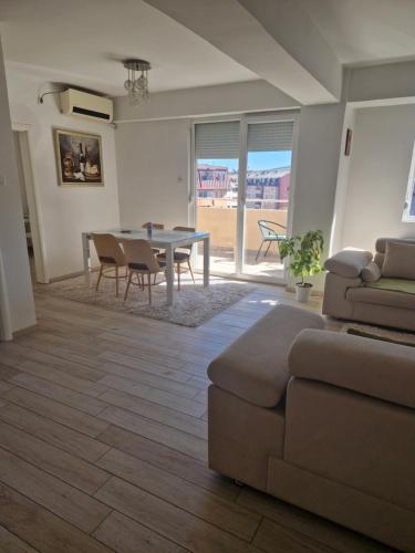 a living room with a table and a couch at Rasadnik Apartment in Skopje