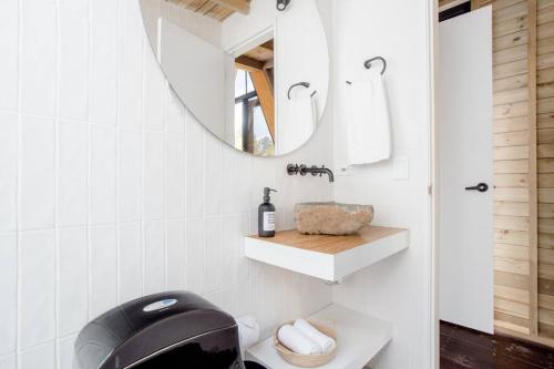 a bathroom with a black toilet and a mirror at KABINE in El Peñol