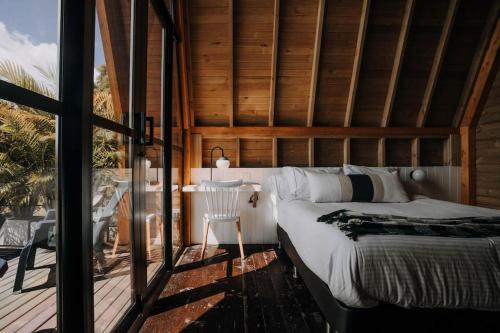 a bedroom with a large bed and a balcony at KABINE in El Peñol
